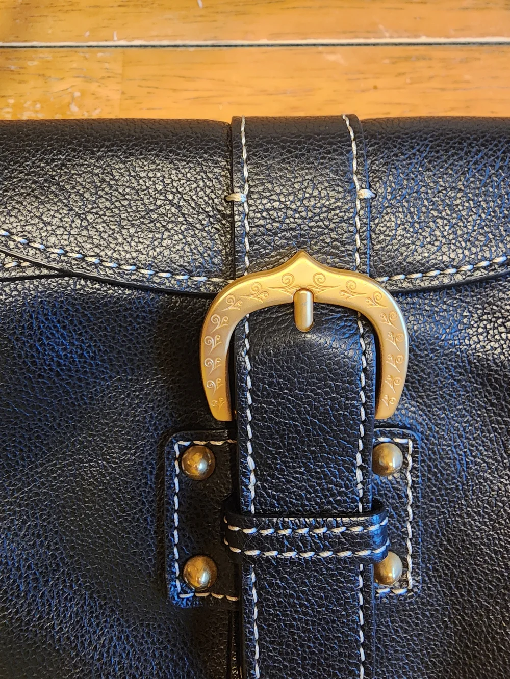 vintage Dooney & Bourke black leather shoulder bag featuring gold-tone hardware